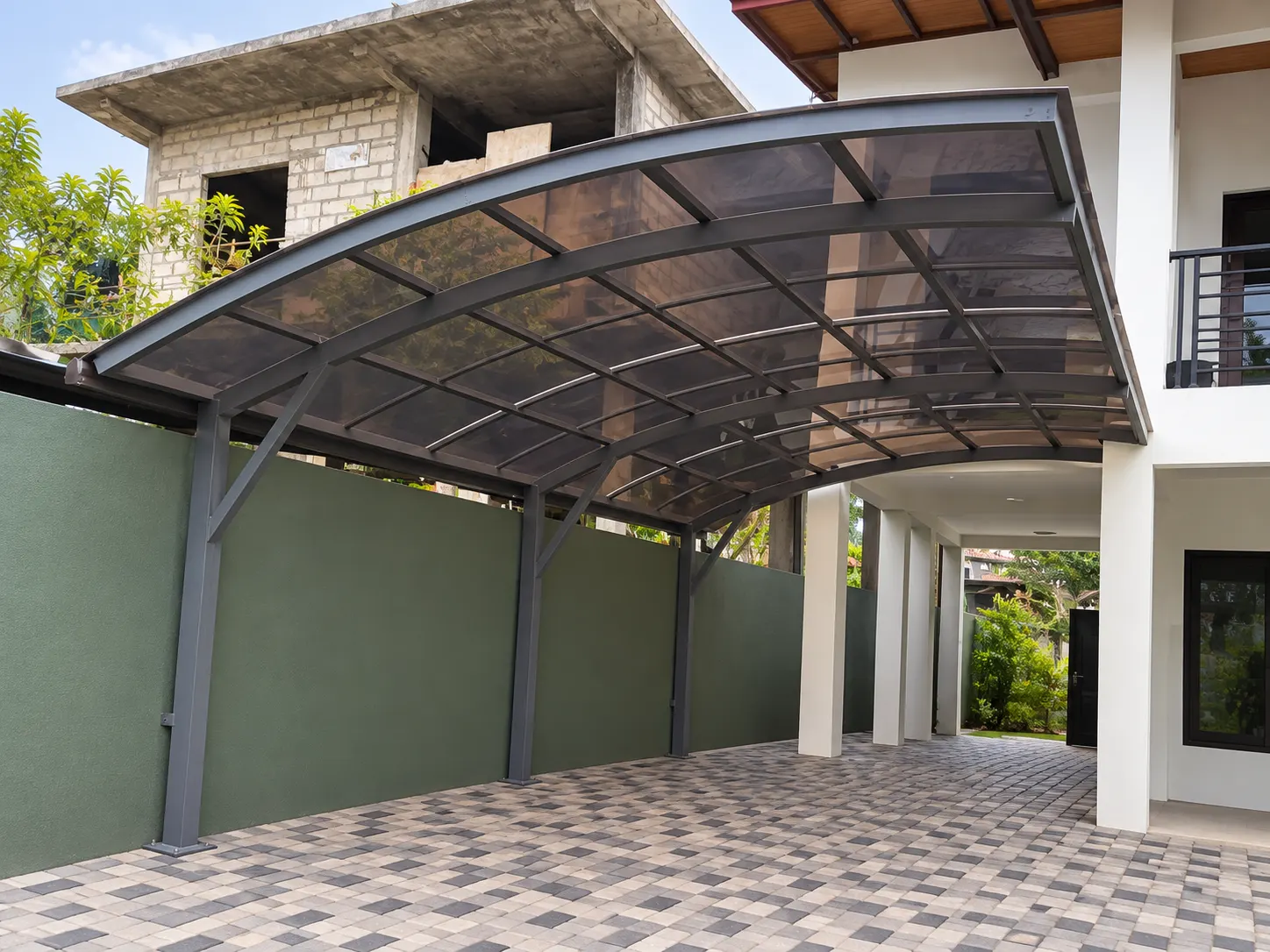 Curved carport alongside a two-storey home