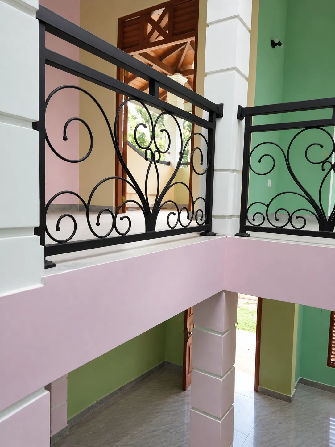 Two sections of scroll railing side by side