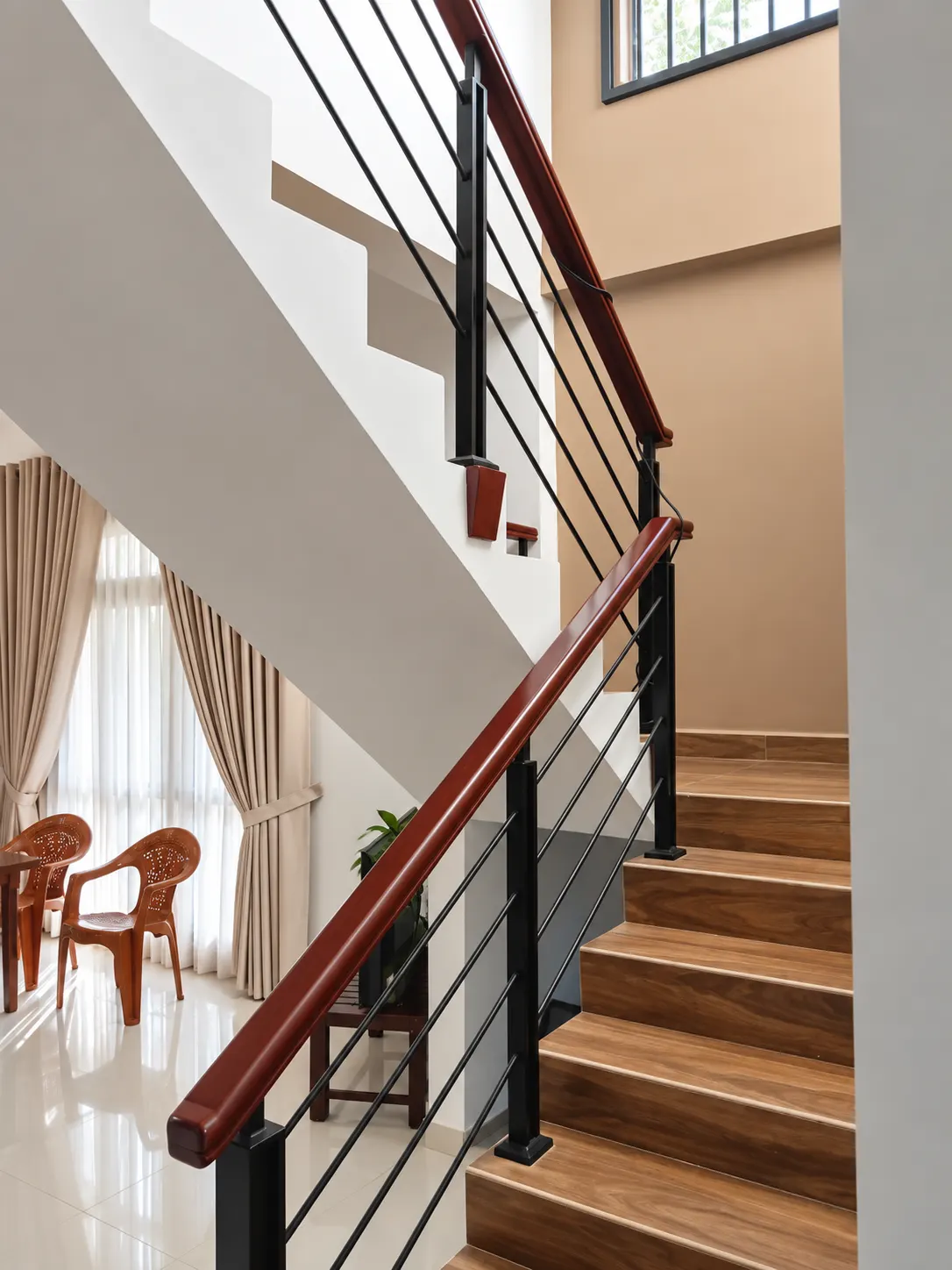Staircase with mahogany handrail and cable infill