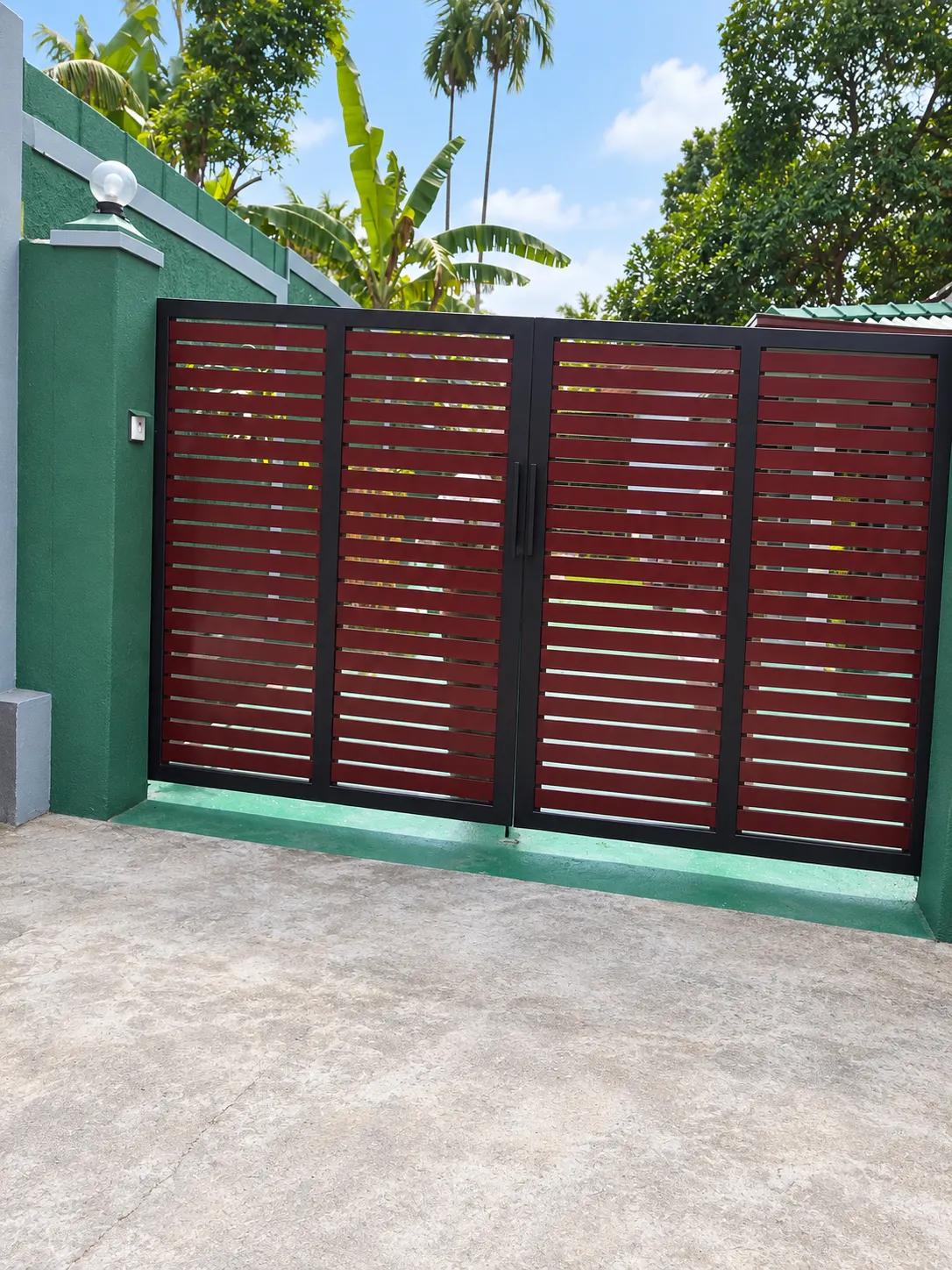 Red slat gate detail, green wall and light fixture
